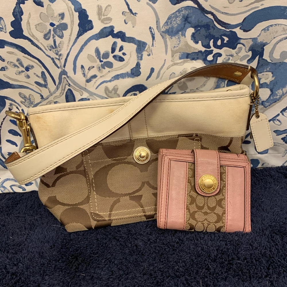 A small coach handbag with a credit card holder.